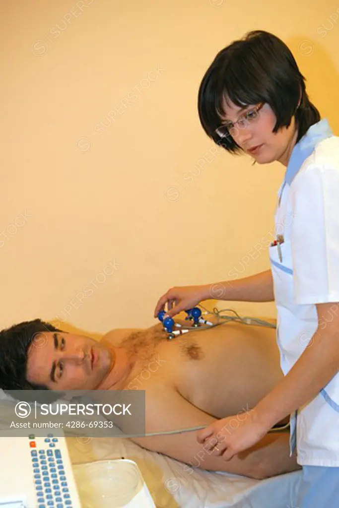 nurse giving man a ECG test