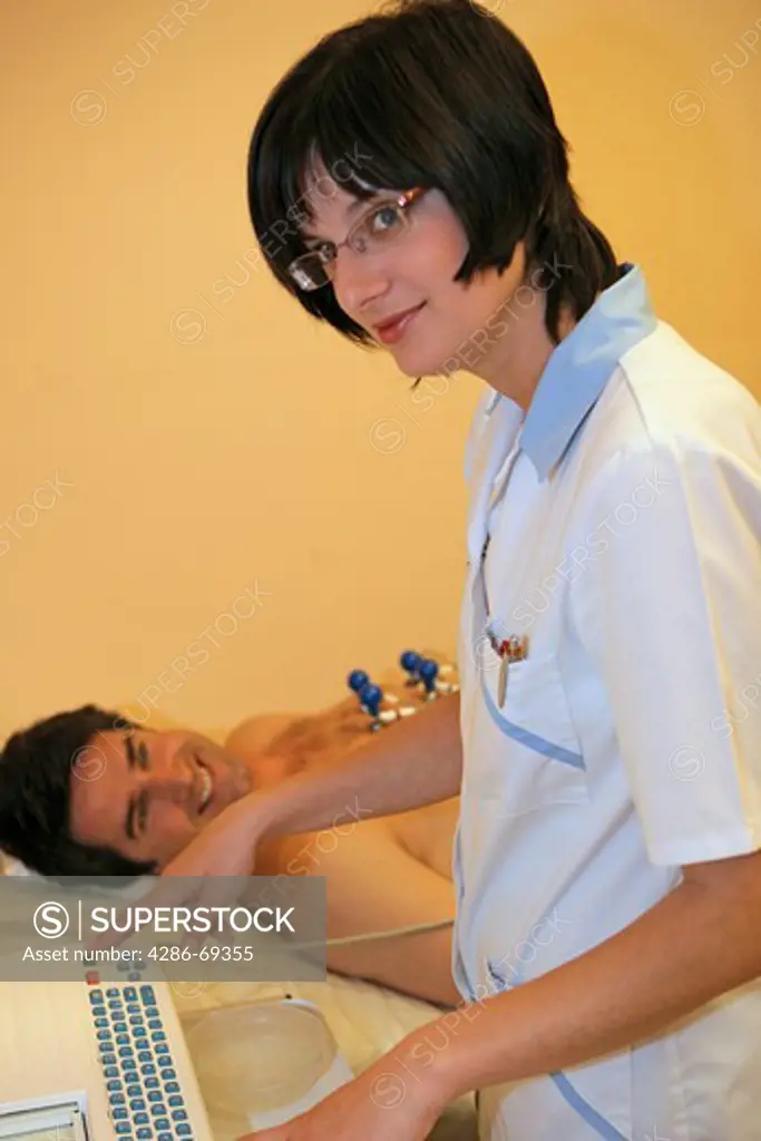 nurse giving man a ECG test