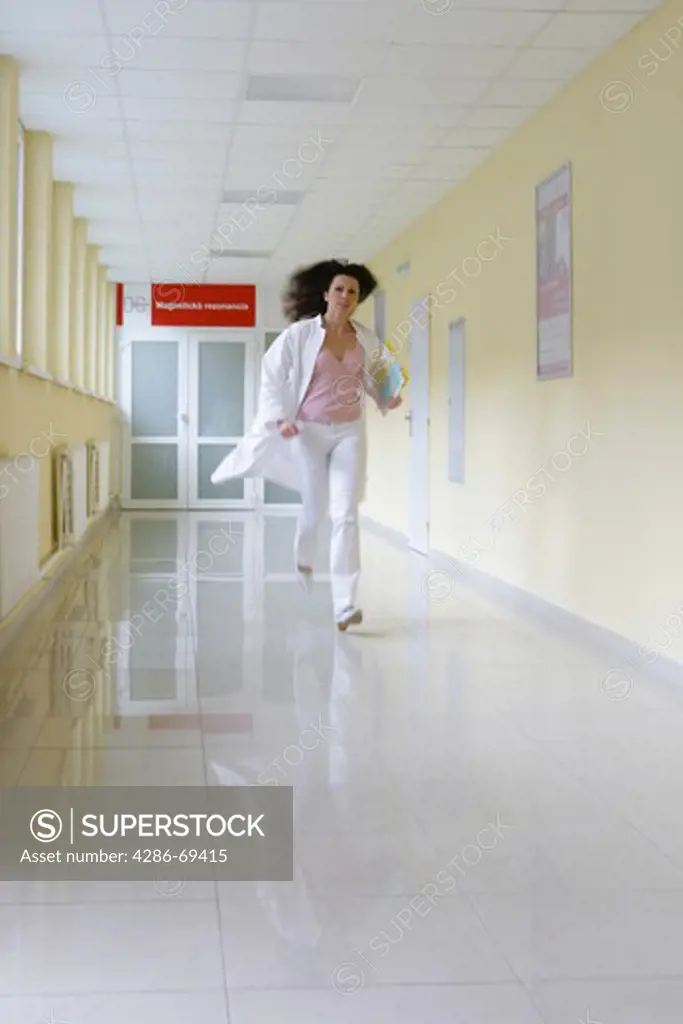 female doctor running in hospital corridor