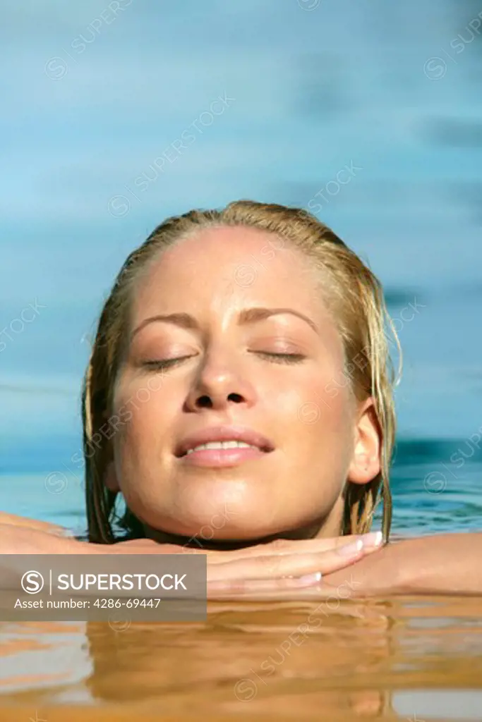 beauty blonde woman enjoying holiday in pool