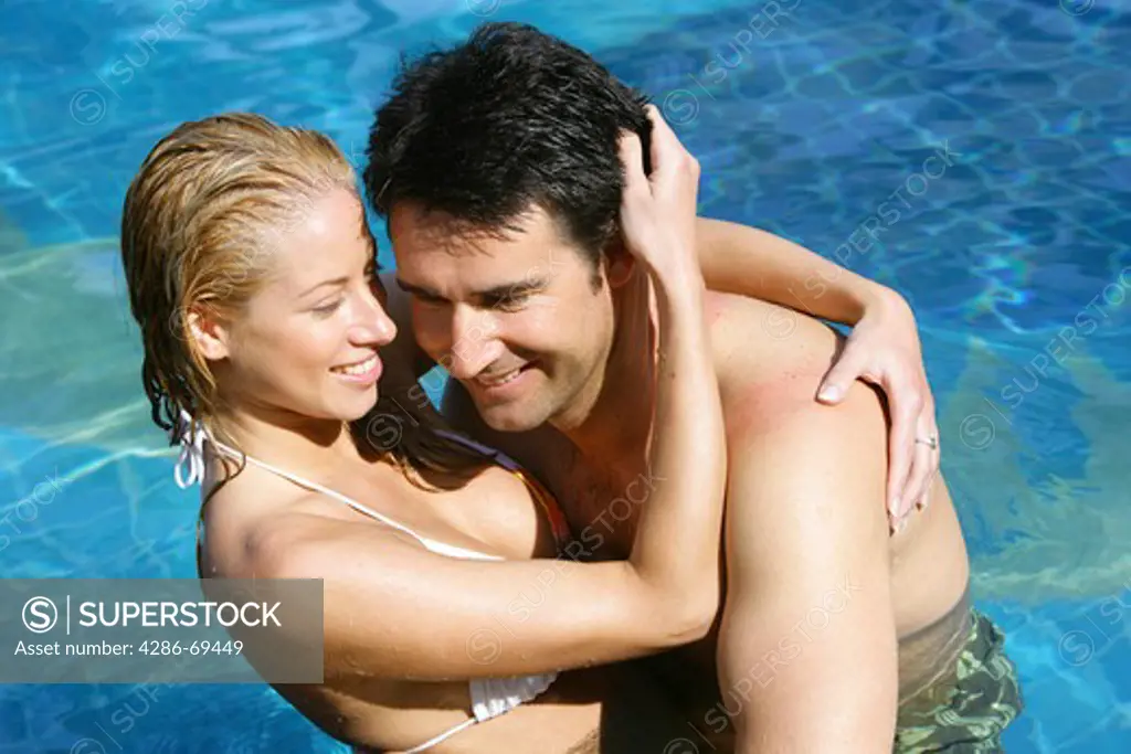 couple in love have fun in pool