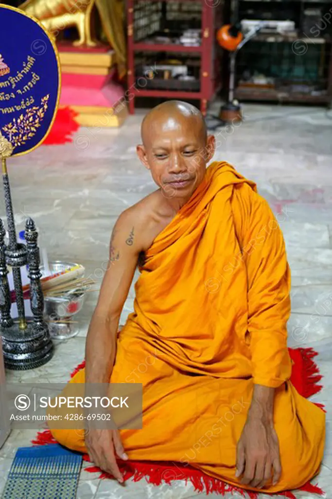 Monk sitting in Wat Tham Seu, tiger cave temple, Krabi