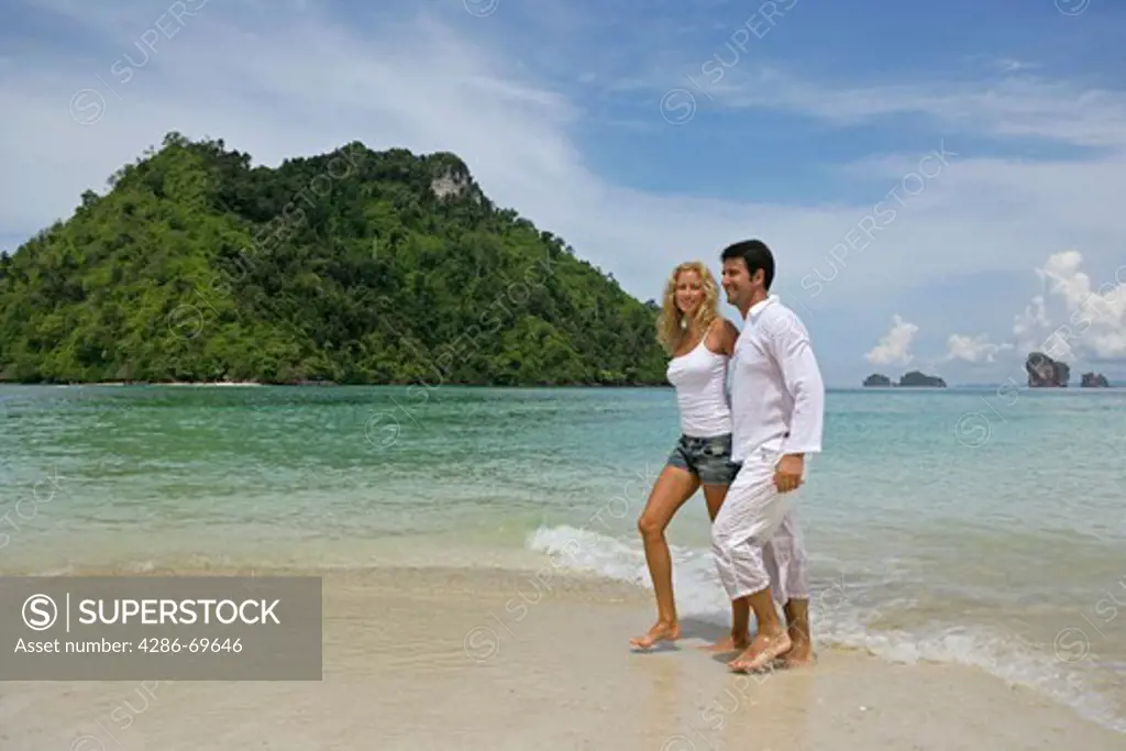 couple in love enjoying holidays at tropical beach in