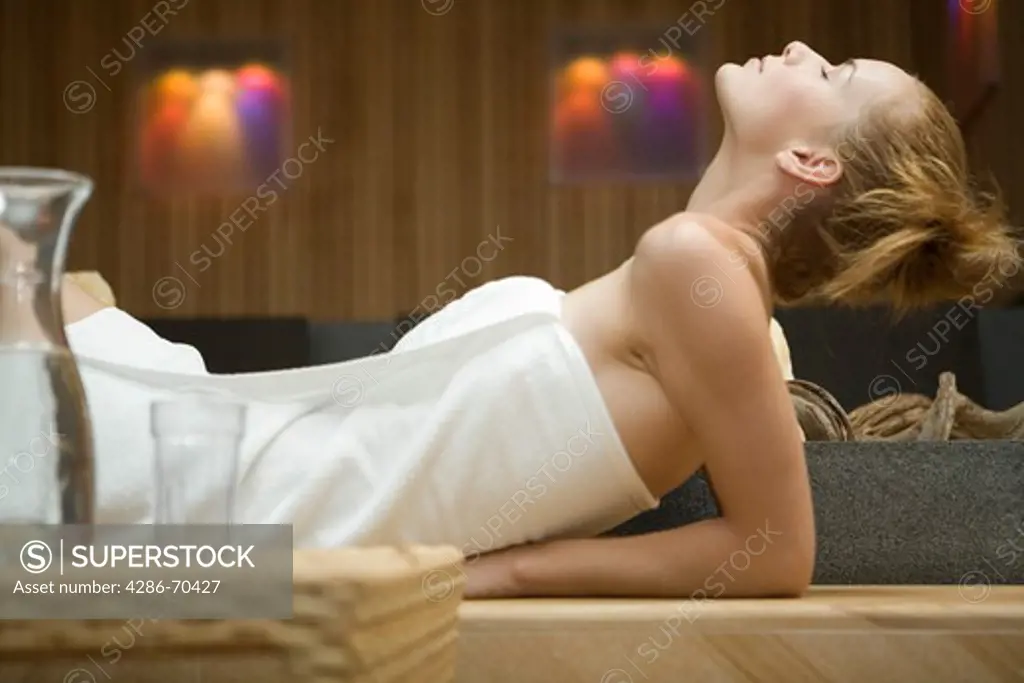 Young pretty woman relaxing in wellness centre.