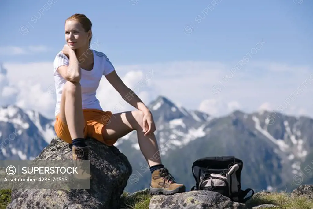 Young pretty woman having rest in the mountains.