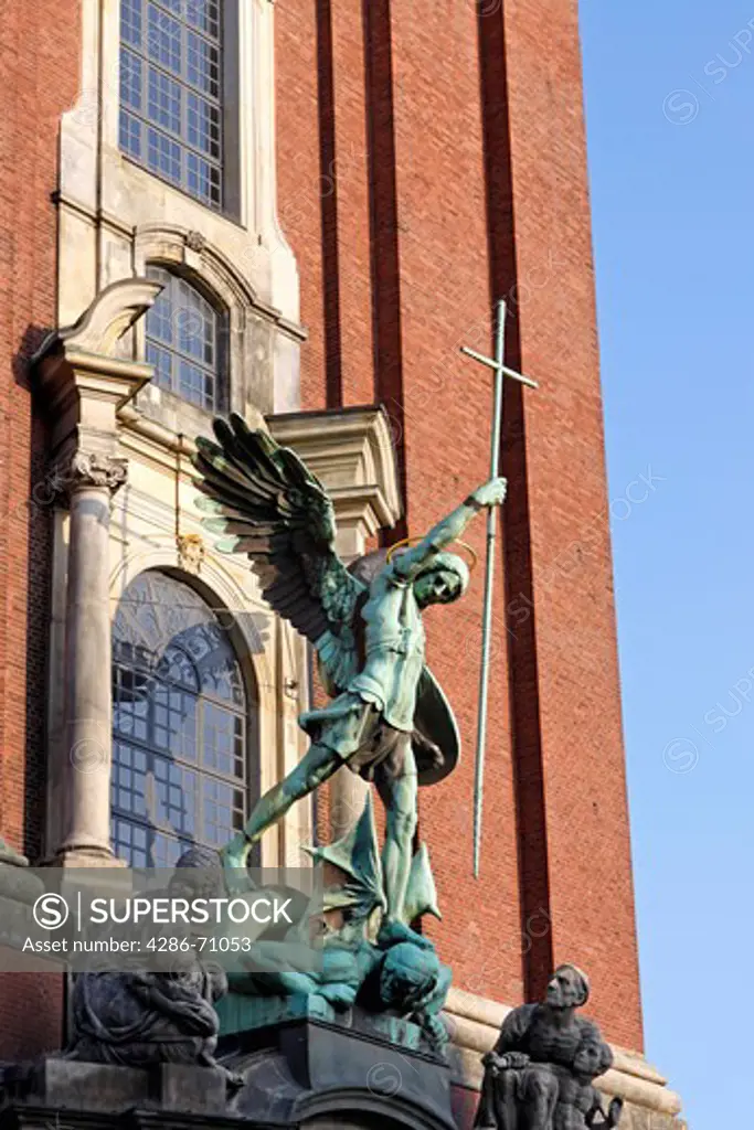 Sculpture archangel Michael defeats the Satan, main main entrance of the church Saint Michaelis, Michel, Hamburg, Germany, Europe