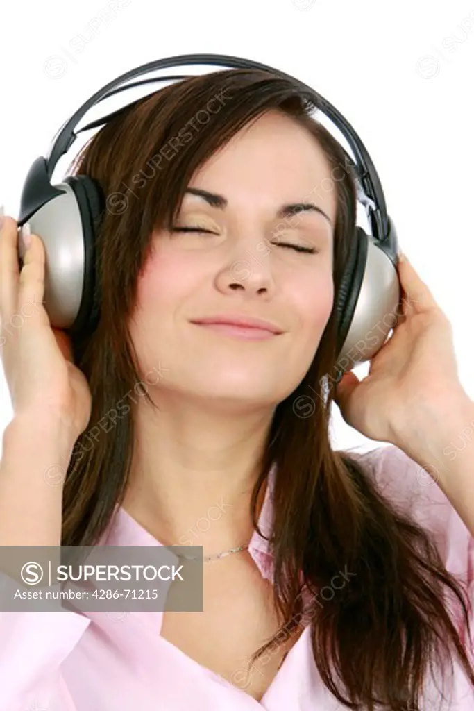 portrait of a young woman listening to music with headphone