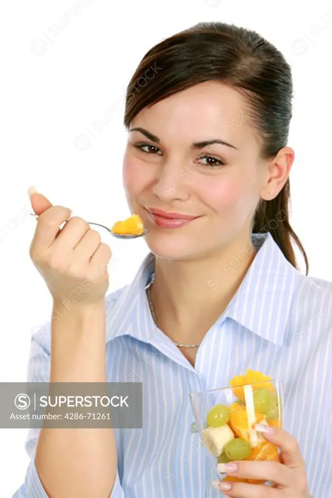 woman enjoys a fruit salad