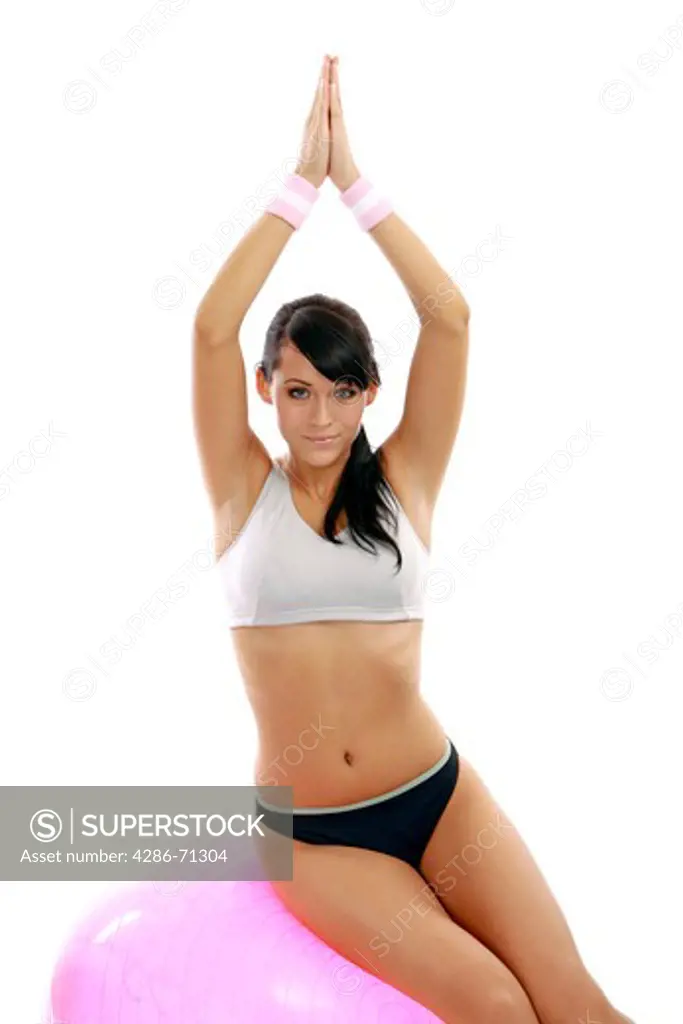 woman makes yoga exercises on exercise ball