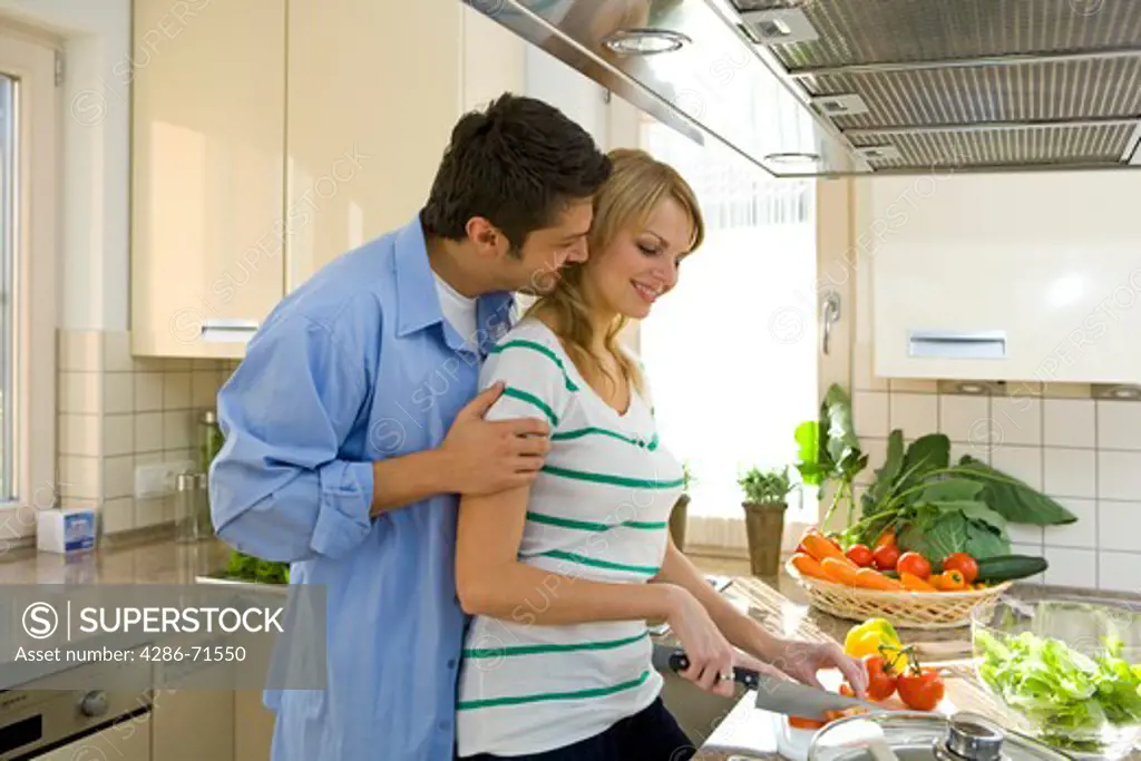 couple working in kitchen