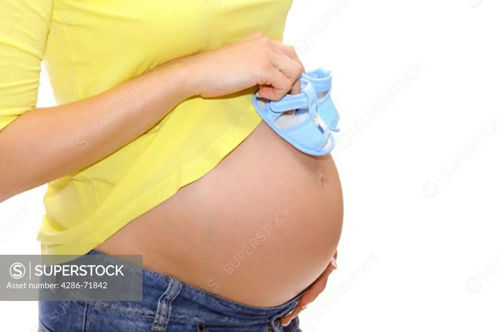 Pregnancy woman, baby shoes
