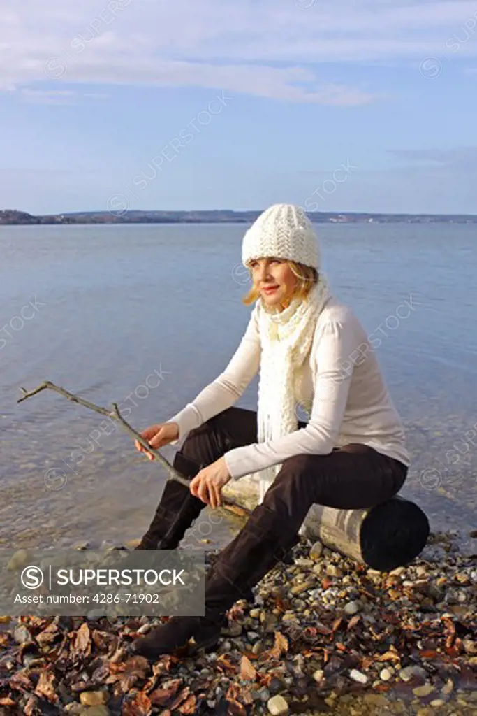 Woman with blonde hair, walking, lake
