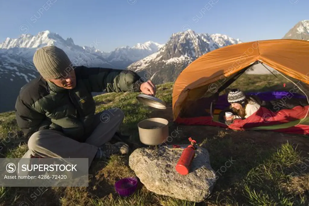 A couple camping in the French alps near Chamonix France.