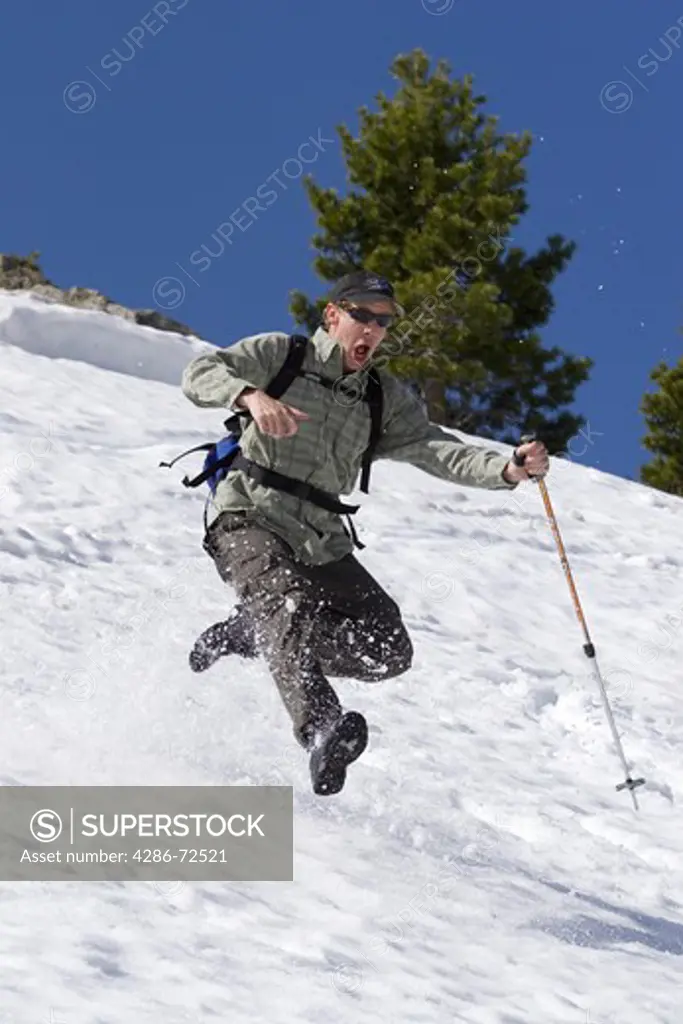A man running through spring snow on Donner Summit in the Sierra mountains of California