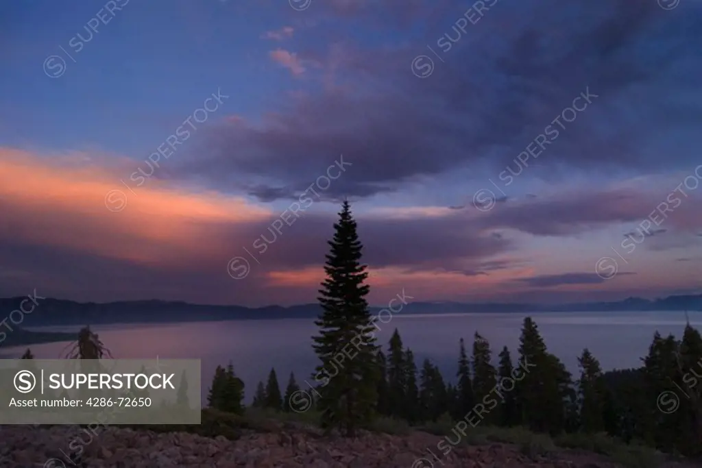 A panorama of storm clouds breaking up over Lake Tahoe at sunset
