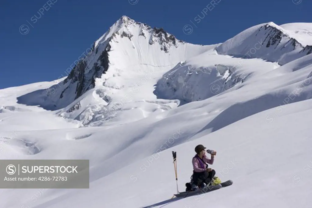A woman ski mountaineering on the Biafo glacier in the Karakoram himalaya of Pakistan