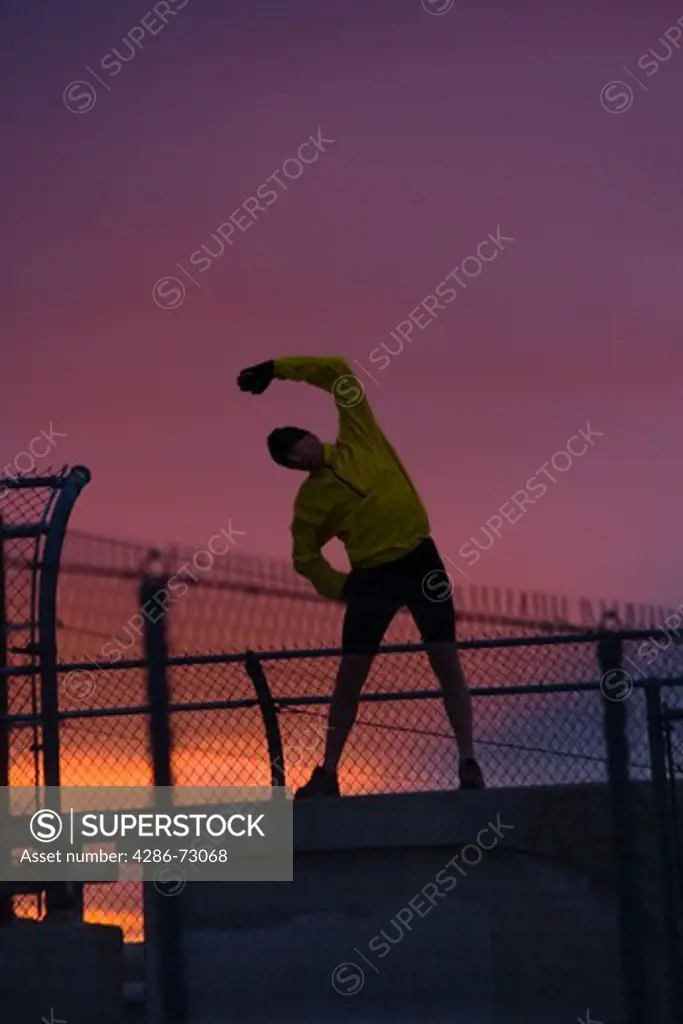 A man stretching before running at sunset in Reno in Nevada