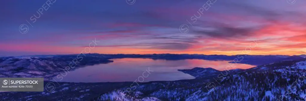  A panorama of Lake Tahoe in California at sunset with alpenglow and clouds