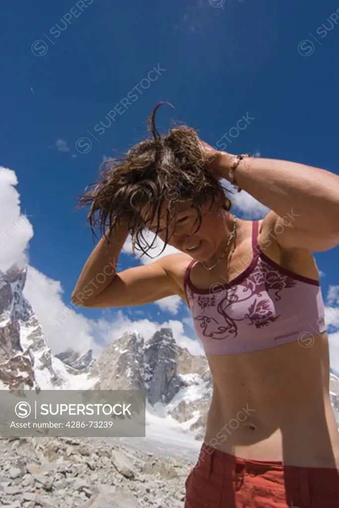 A woman washing her hair on the Biafo Glacier in Baltistan in Pakistan
