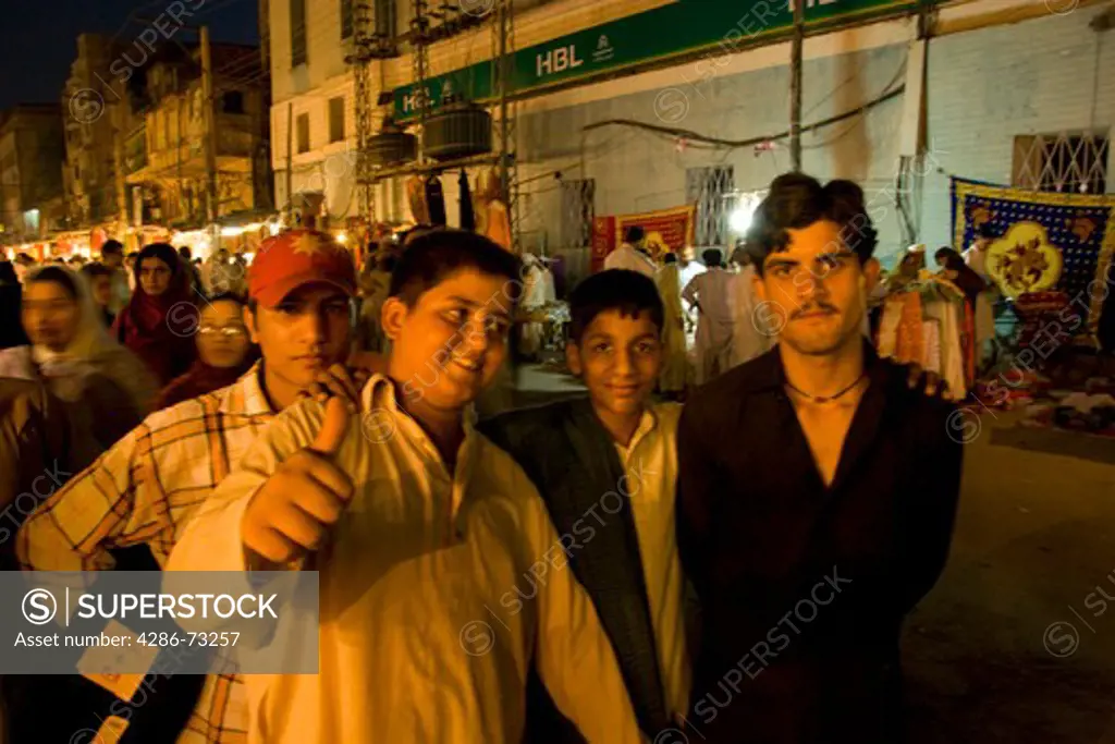 A group of boys at night in the old bazaar in Rawalpindi Pakistan