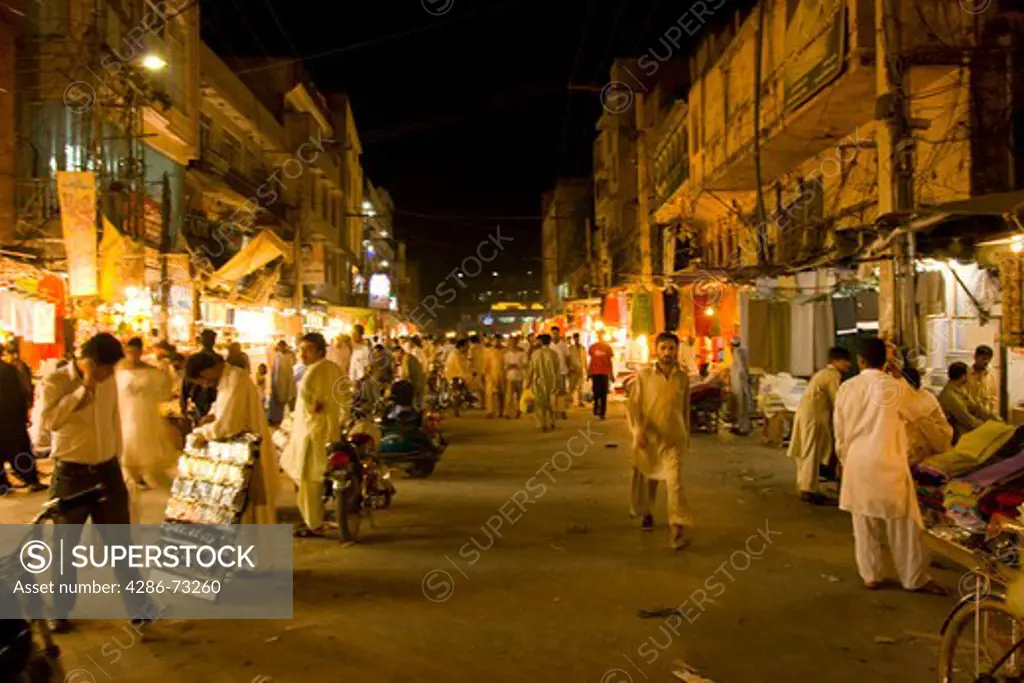 Crowds of people at night in the old bazaar in Rawalpindi Pakistan