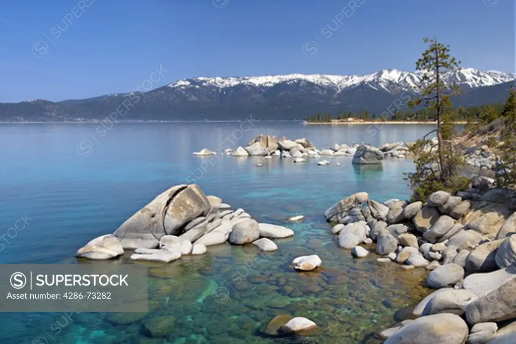  Whale rock and snowy mountains on the east shore of Lake Tahoe in the spring