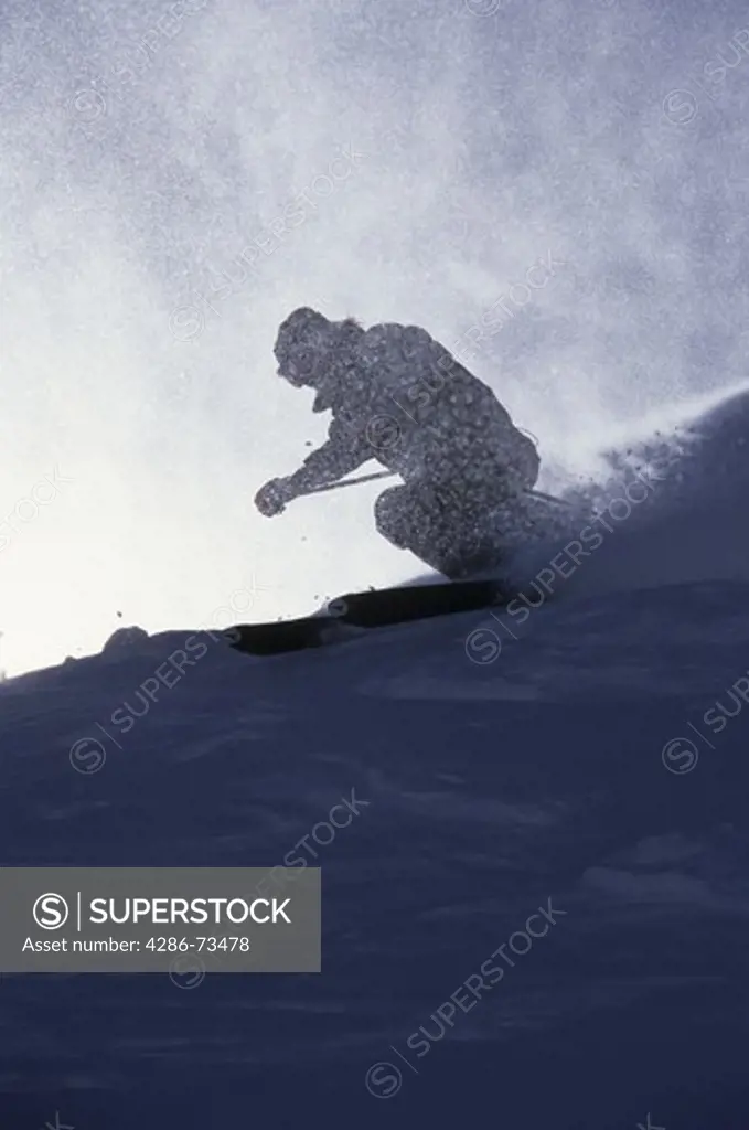 Skier on snow slope of Sugarbowl ski area near Lake Tahoe, California, USA