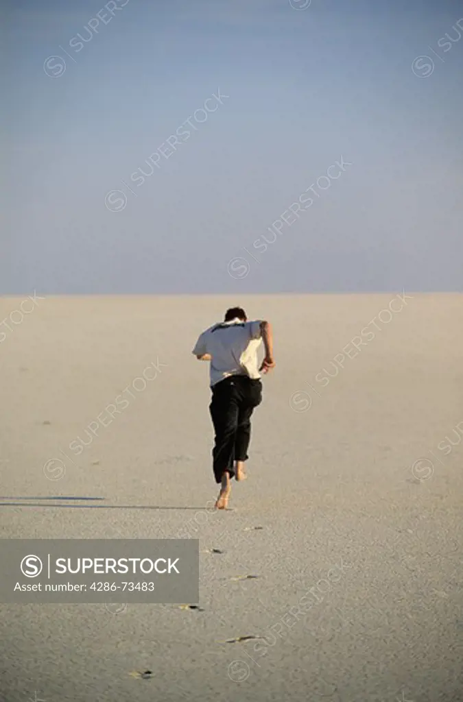 Young man running on the Bonneville Salt Flats in Utah, USA
