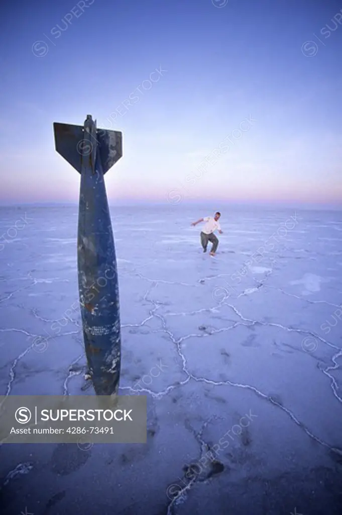 Young man looking at old missile at the Bonneville Salt Flats in Utah, USA
