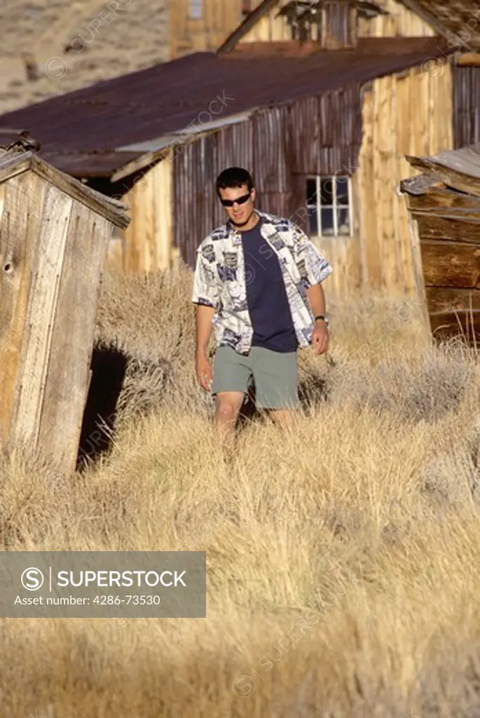 Young man walking at Bodie State Park, California, USA