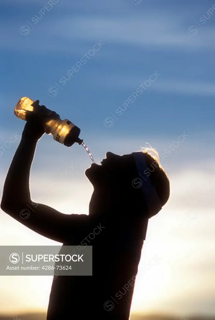 Silhouette of person drinking water in Death Valley, Nevada, USA