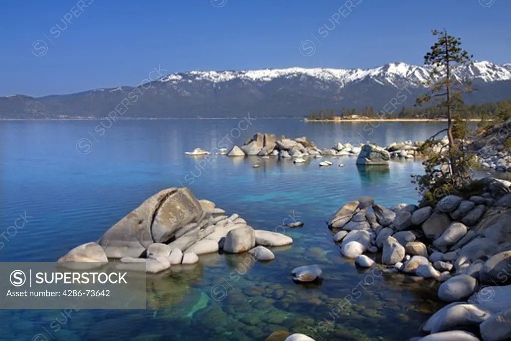Whale rock and snowy mountains on the east shore of Lake Tahoe in the spring