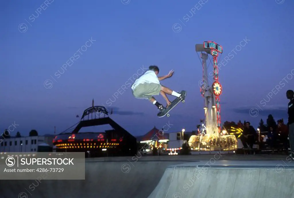 Skateboarder in midair at skatepark in Truckee, California, USA