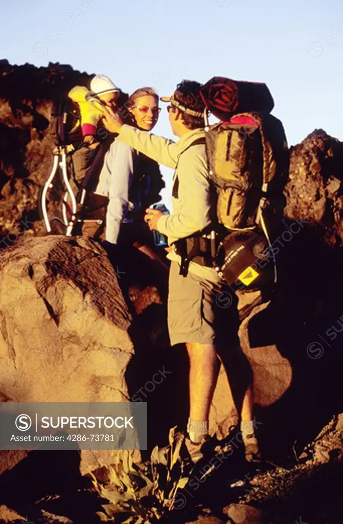 Young family backpacking at Mount Judah in the Sierra mountains near Truckee, California, USA
