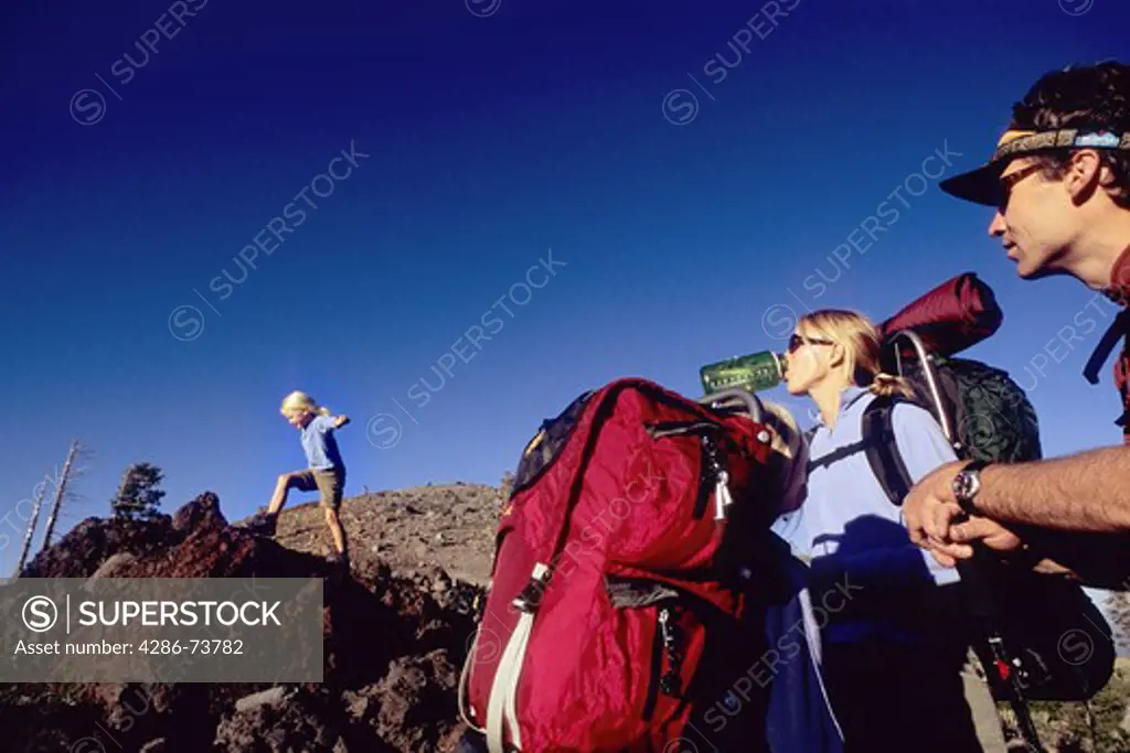 Young family backpacking at Mount Judah in the Sierra mountains near Truckee, California, USA