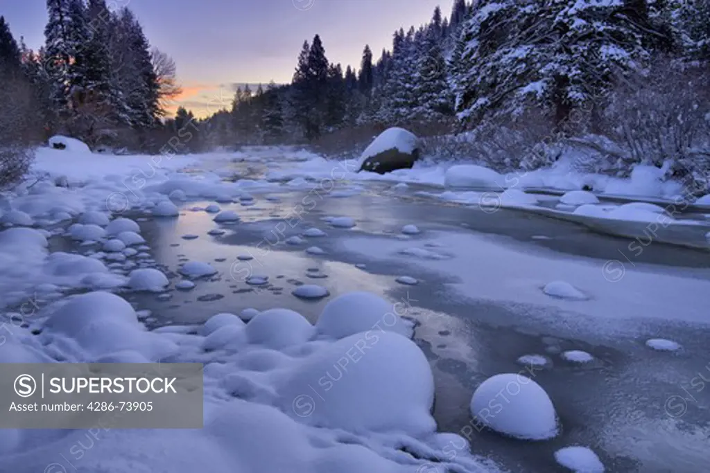 The Truckee River at sunrise in winter with snow