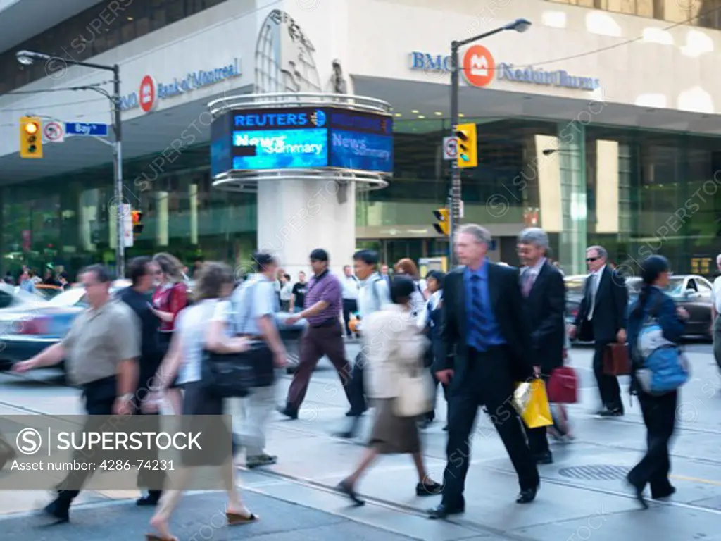 Canada,Ontario,Toronto,pedestrians crossing street in the financial district of the city 