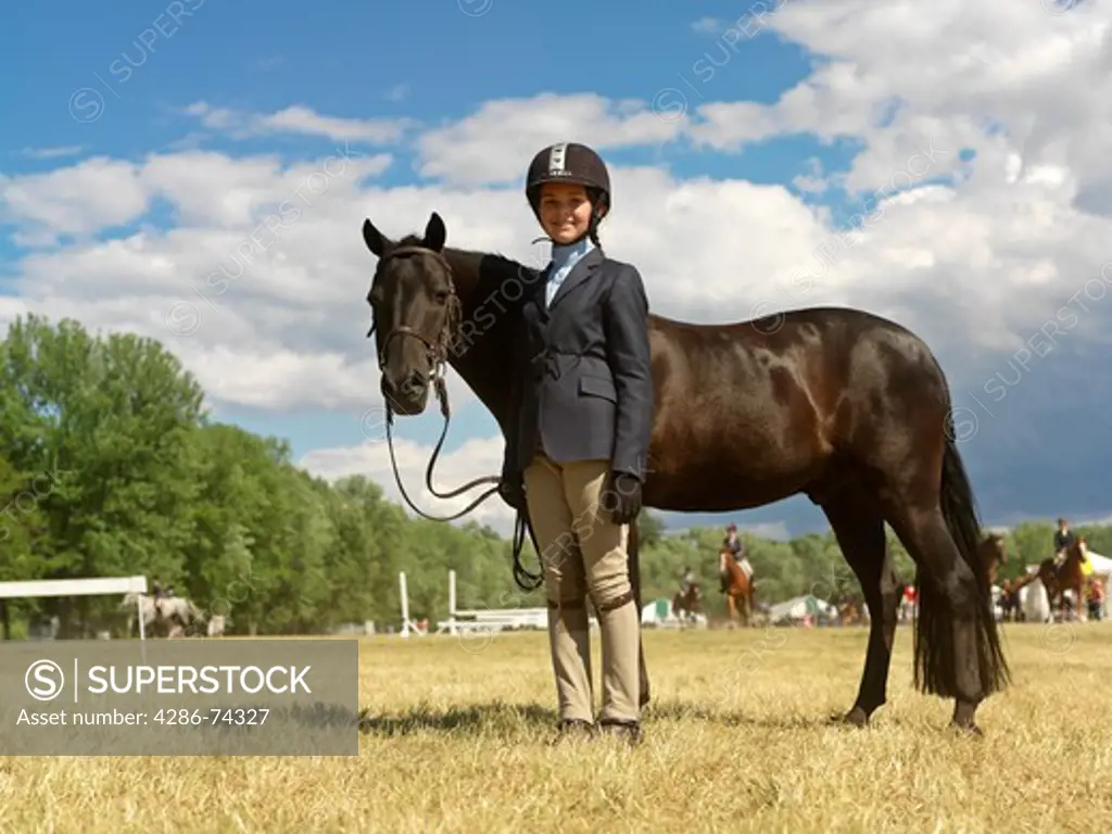 Canada,Ontario,Niagara-on-the-Lake, equestrain teenage girl posing with her horse