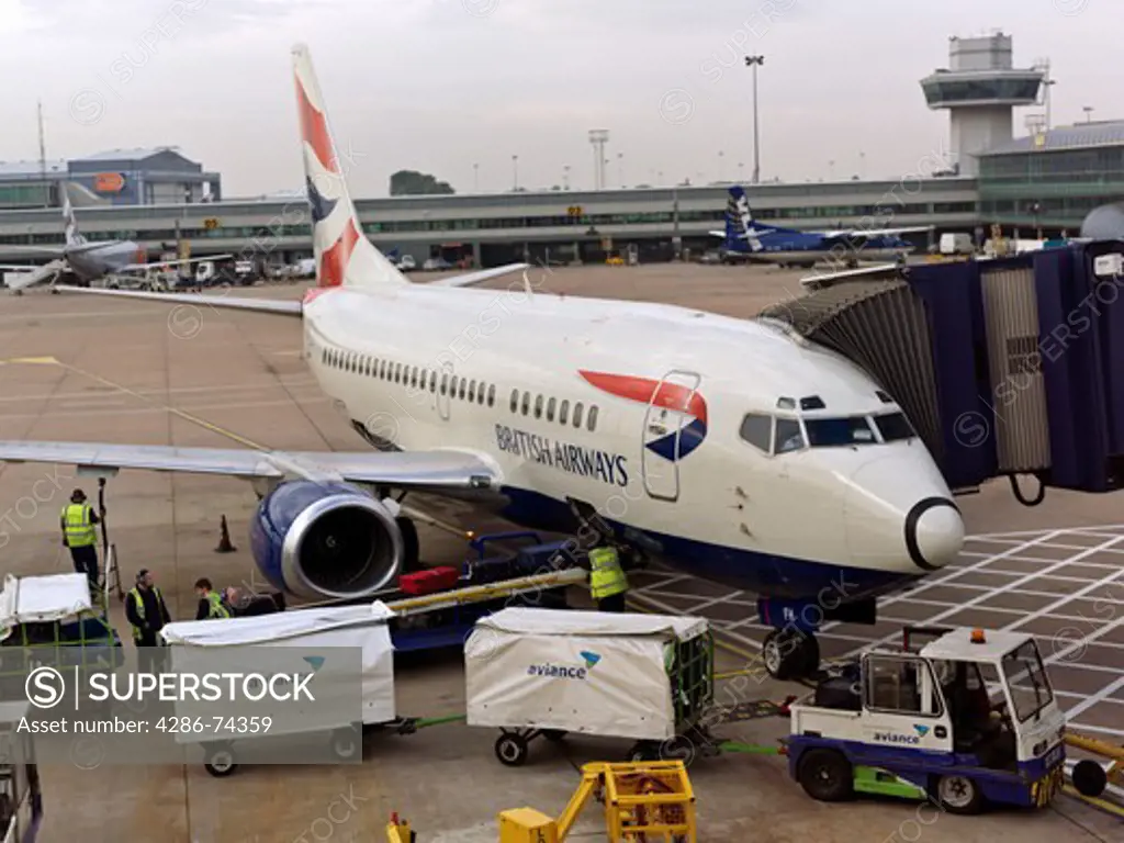 United Kingdom London Heathrow Airport,British Airway plane at terminal with bagage being unloaded