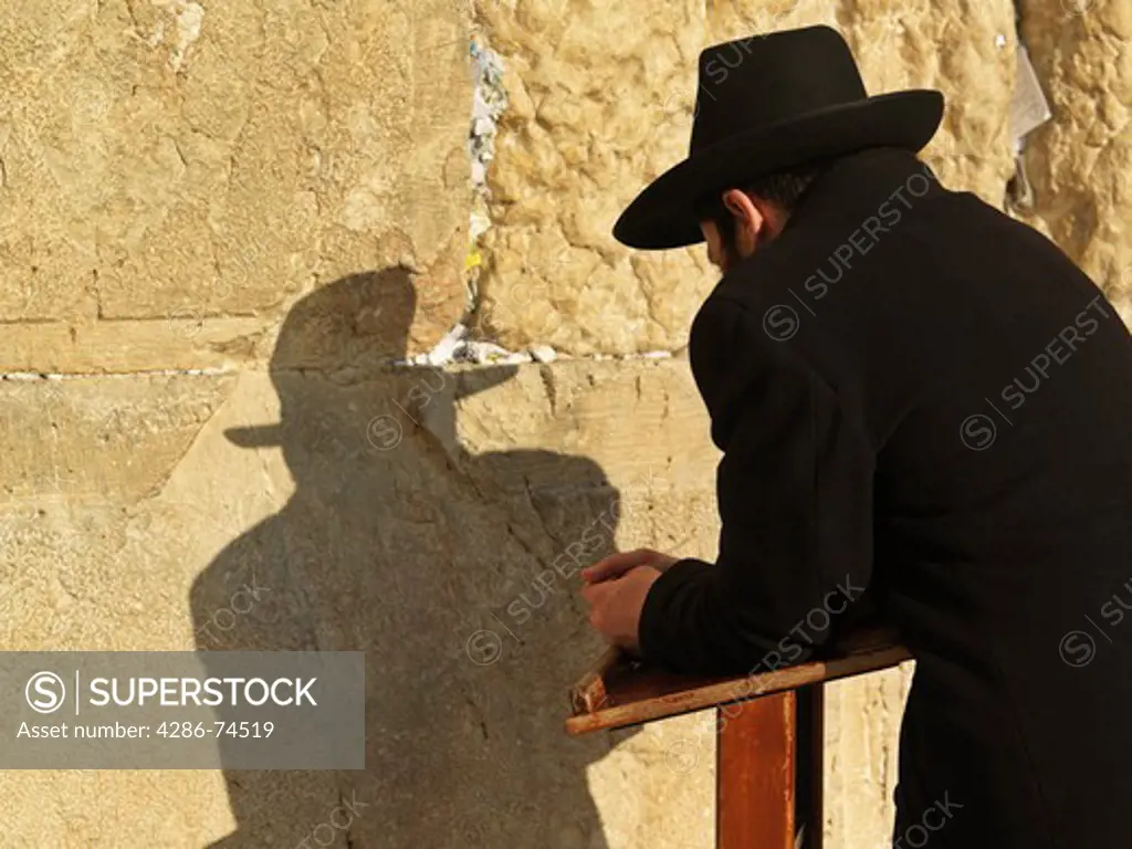 Israel, Jerusalem, Western Wall or Wailing Wall with worshipper and prayer slips