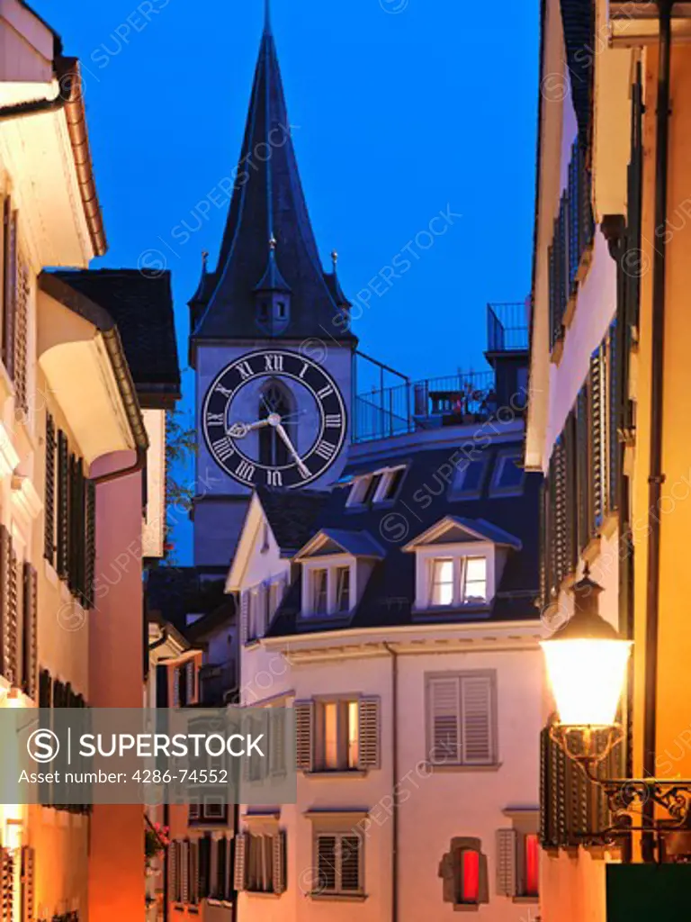 Switzerland, Zurich,Old Town Zurich, street scene with view of St. Peter's Church clock tower at dusk