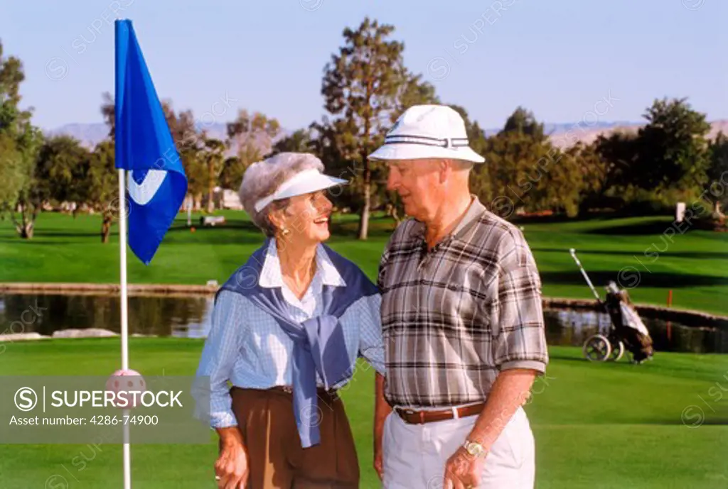 Couple in their 70s playing golf in Palm Springs California