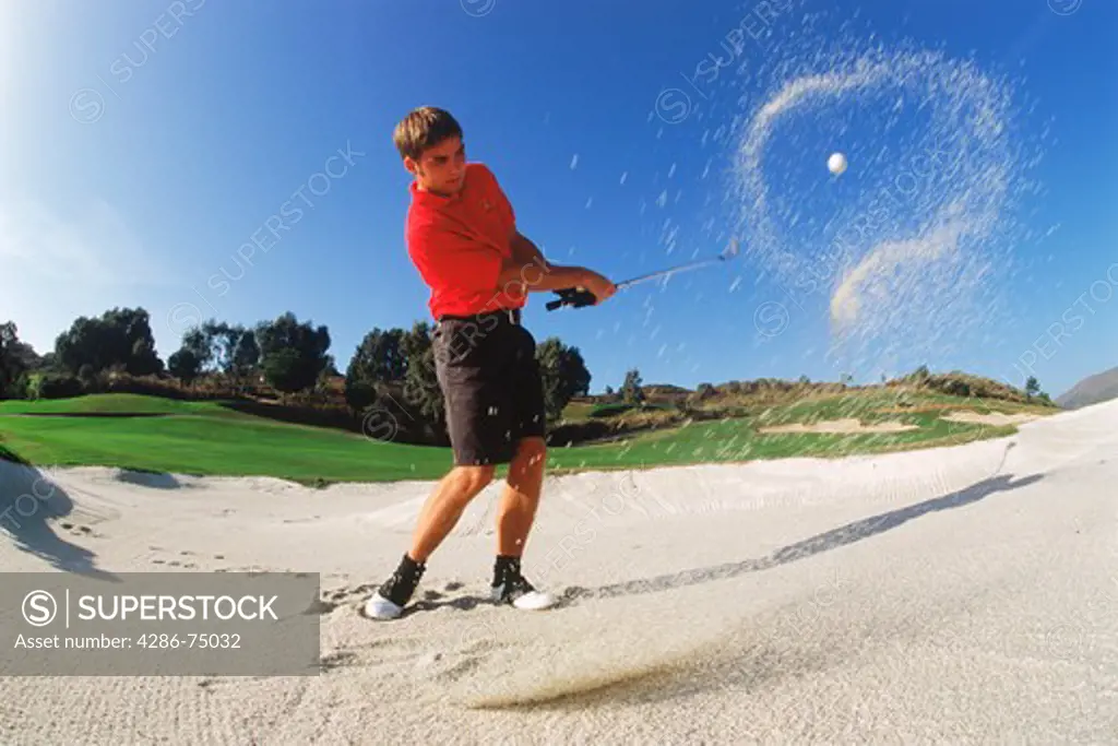 Halo of sand encircliing golf ball hit from bunker
