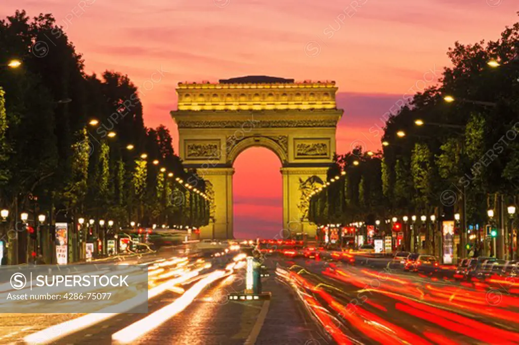 Traffic on Champs Elysees with Arc de Triomphe in Paris at dusk