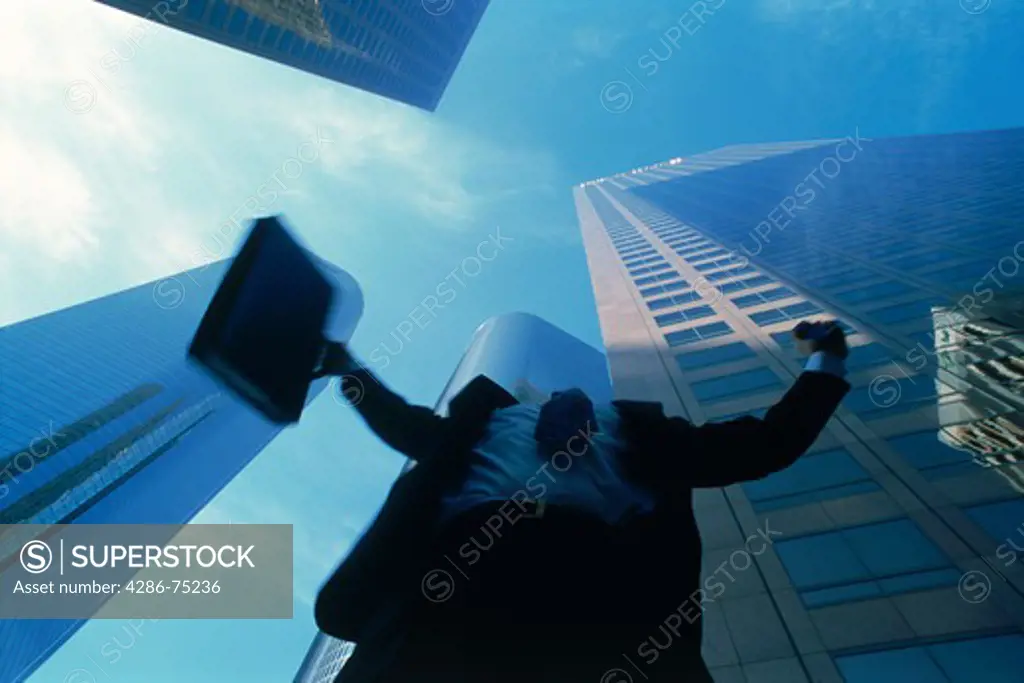 Businessman raising arms in downtown Los Angeles