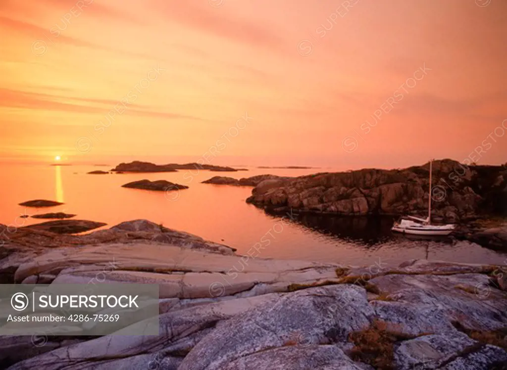 Sailboat anchored on small Lilla Nassa island at sunset in Stockholm Archipelago