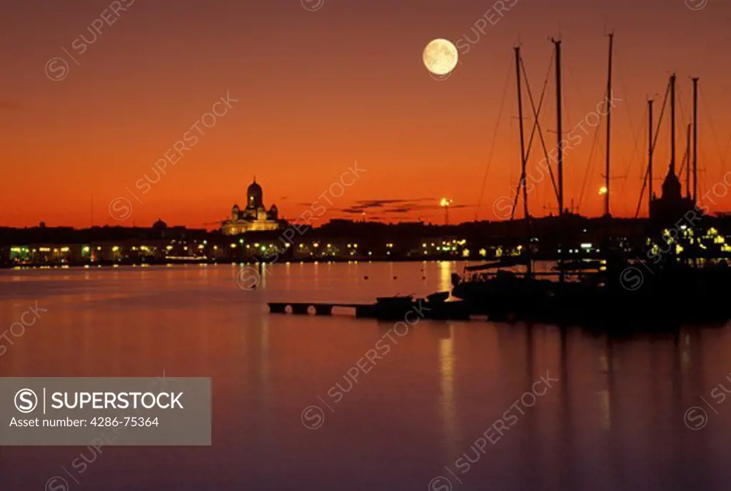 Senate Square Cathedral over South Harbor with yachts under full moon Helsinki Finland