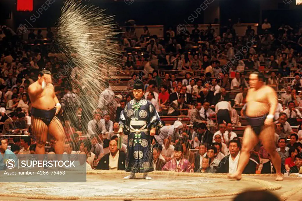 Pre fight sumo wrestling ceremony of tossing salt into ring or dohyo