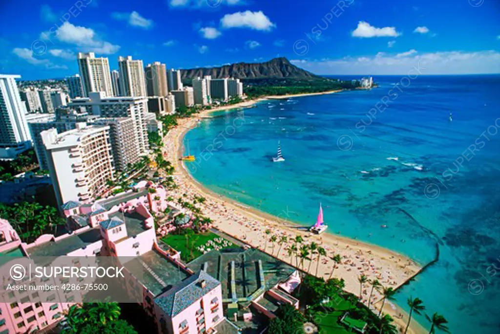 Waikiki Beach and Diamond Head with beachfront hotels and catamarans on Oahu Island in Hawaii