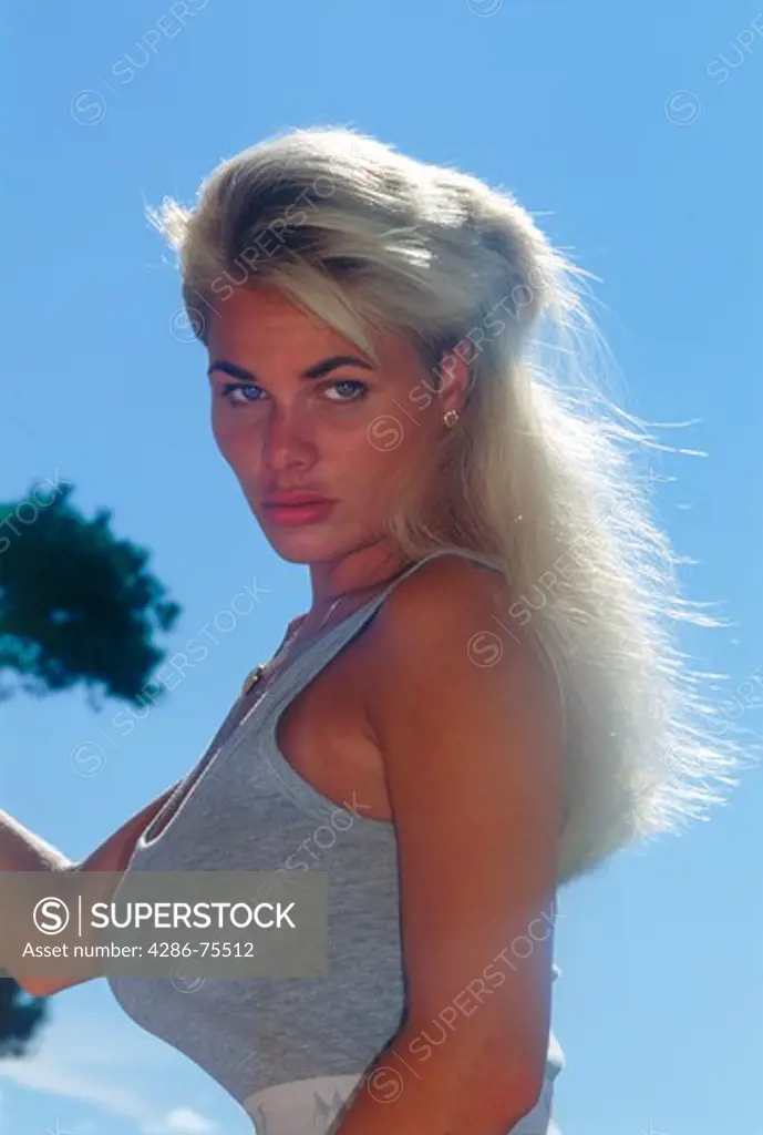 Blond woman of Brazilian Swedish ethnicity sun bathing